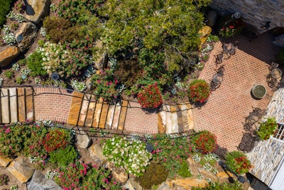 This hardscaping project, featuring Glen-Gery’s 53-DD pavers, utilizes the key principles of biophilic design, creating a blended, harmonious environment with overlapping pathways and foliage.
