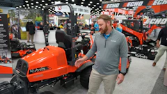 Bright orange Kubota tractor on display at industrial equipment trade show