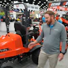 Bright orange Kubota tractor on display at industrial equipment trade show