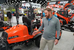 Bright orange Kubota tractor on display at industrial equipment trade show
