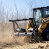 For grass, brush, and smaller woody material, look to brush cutters. When the work involves standing trees or heavier debris look to mulching attachments.