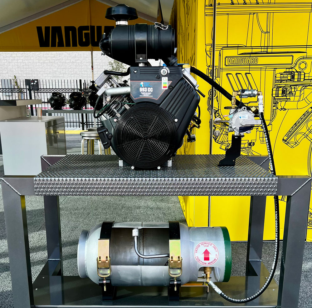 Industrial engine and air compressor equipment displayed on metal platform with technical specifications and Vanguard branding