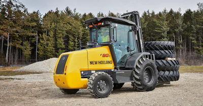 Yellow and black New Holland compactor roller parked on gravel with forest trees in background