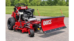 Red Ferris zero-turn mower with Boss snow plow attachment on asphalt driveway