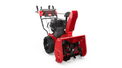 Red and black Toro two-stage snow blower with engine and chute on white background