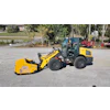 Yellow New Holland wheel loader with Arctic snow pusher attachment parked at equipment yard